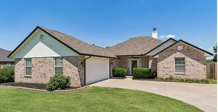 Brick and siding single-story home with a two-car garage in Piedmont